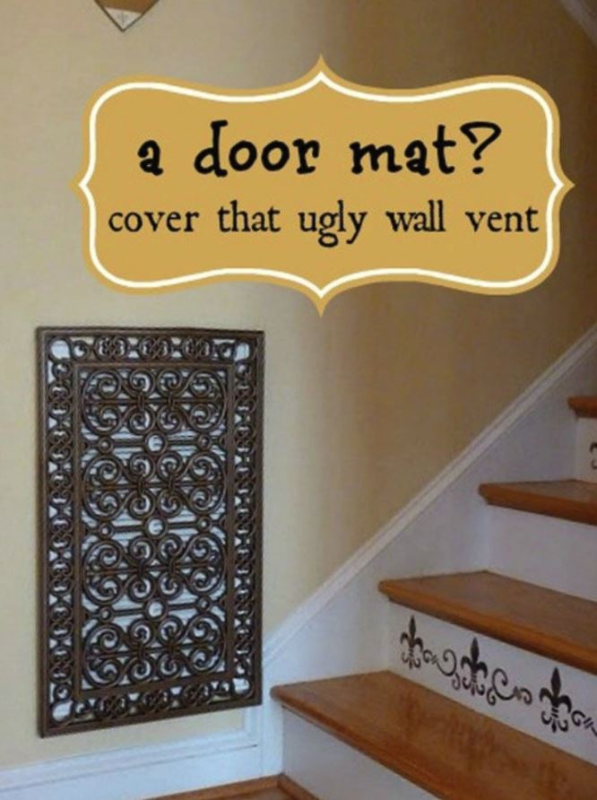 A doormat being used to cover ugly air vent
